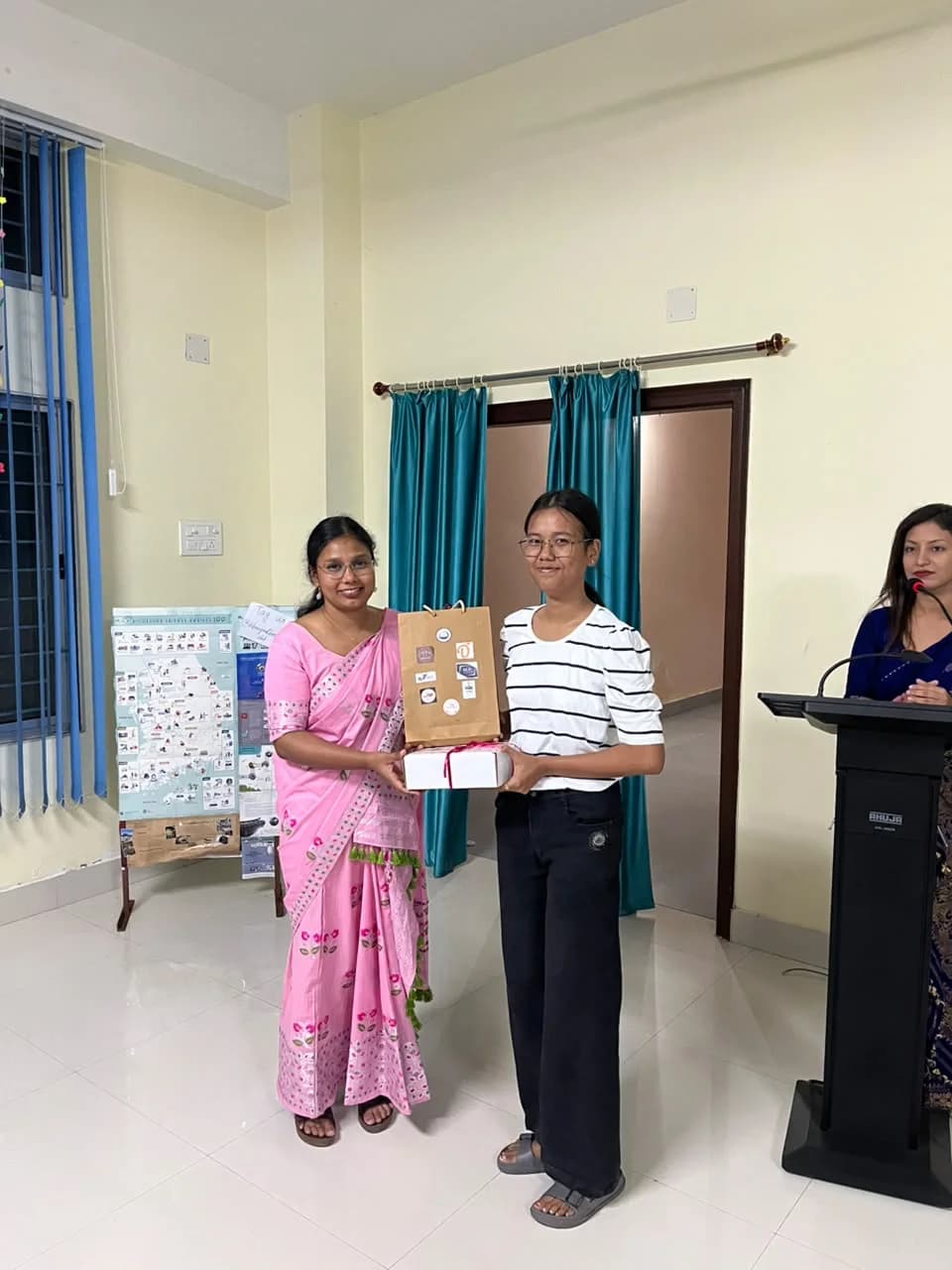 A participant receiving a gift bag and box