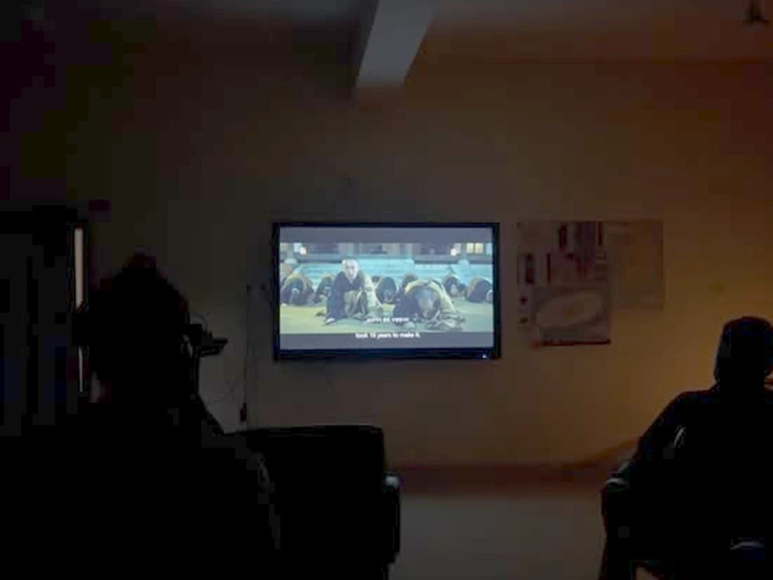 The film playing as the audience watches